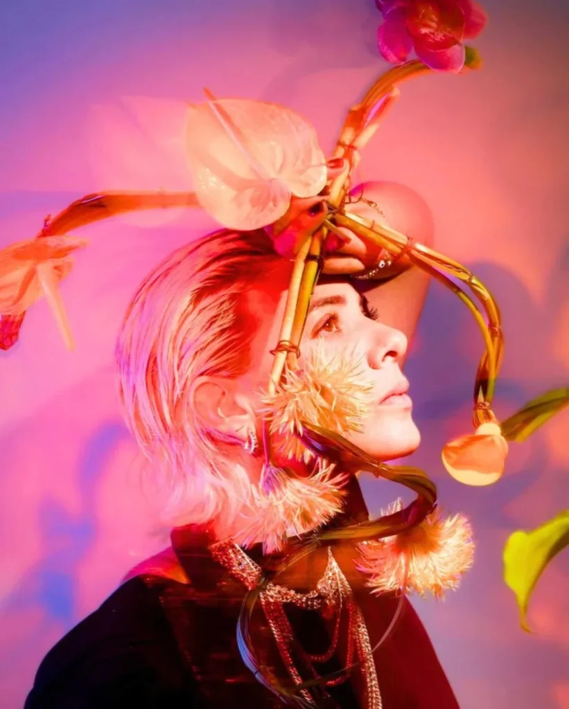 Contemporary floral design by Michelle Pourroy featuring an artistic floral headpiece with orchids and sculptural stems.
